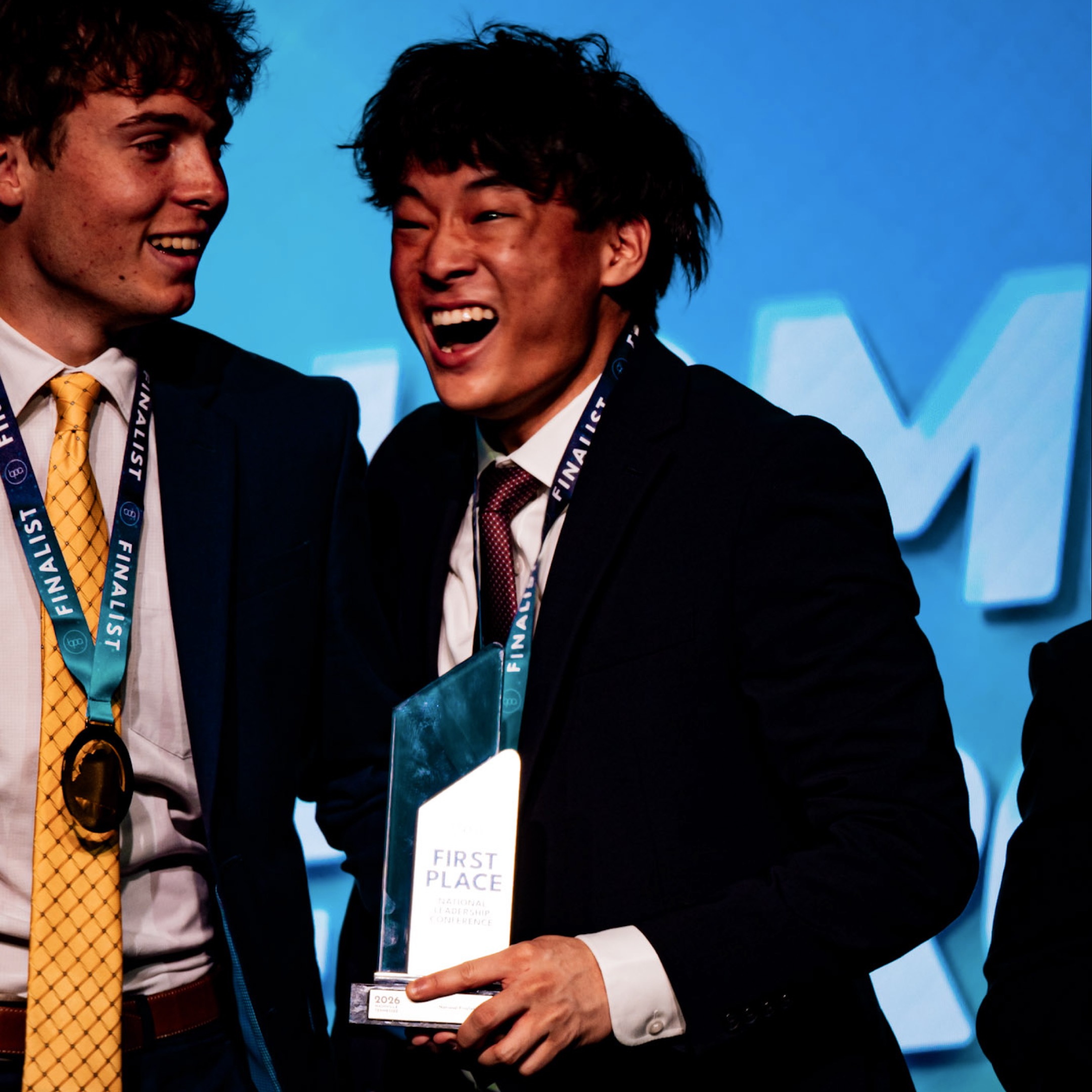 Man laughing with First Place trophy — BPA National Leadership Conference