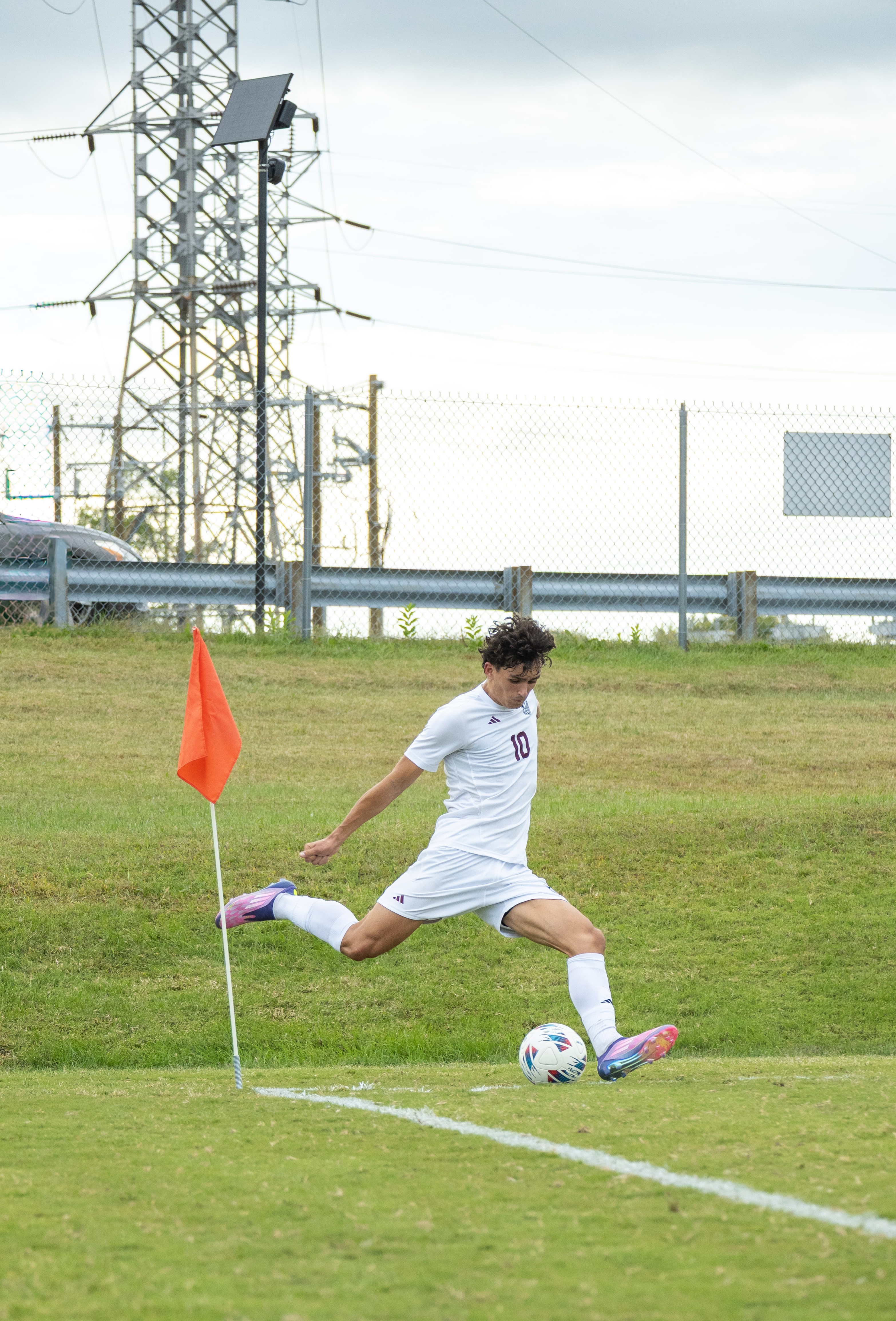 Soccer player taking corner kick, color action shot