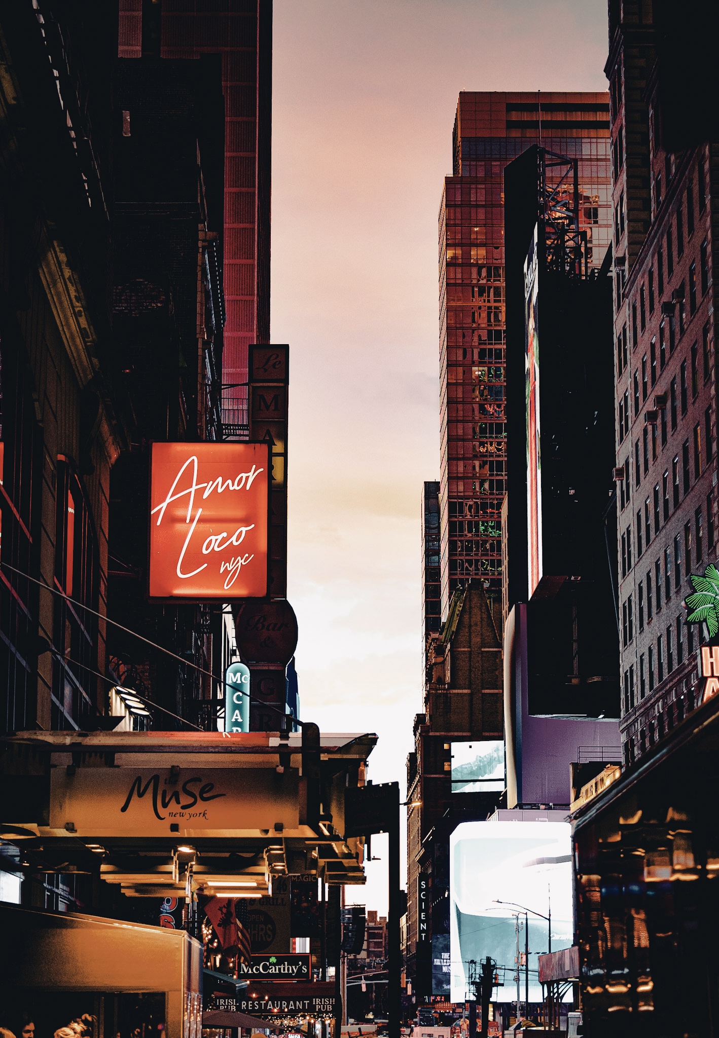 NYC street at dusk â€” Amor Loco and Muse New York neon signs